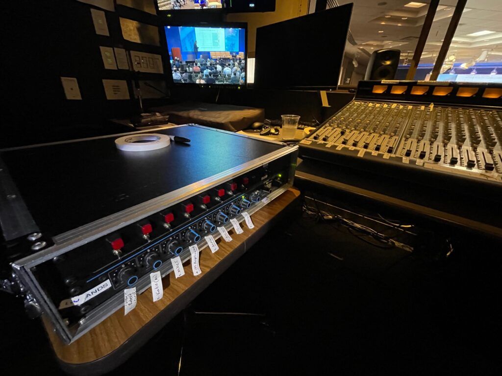 Automatic mic mixer added to traditional analog mixing console for a corporate meeting and web stream in NYC